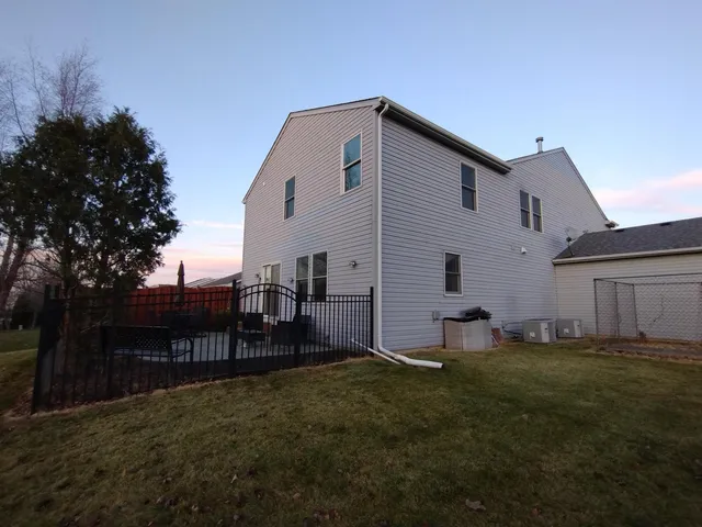 a backyard of a house with table and chairs