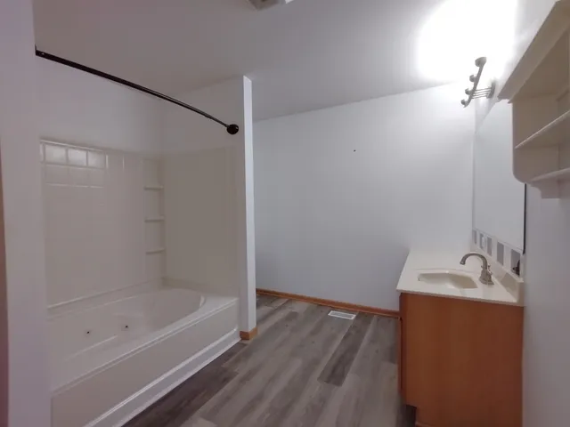 a bathroom with a bathtub and a sink