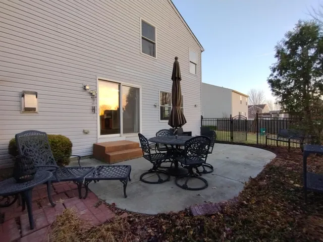 a view of a patio with table and chairs and potted plants