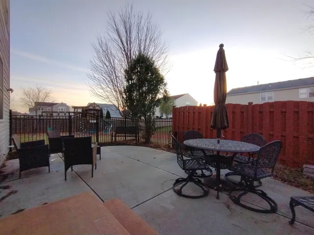 a view of a chairs and table in the patio