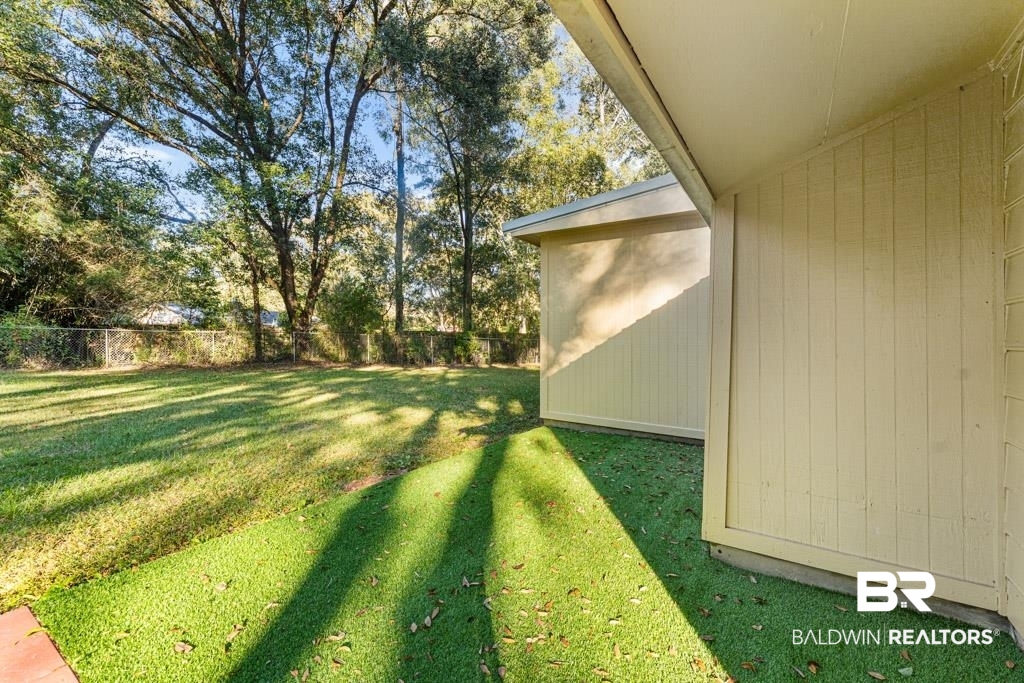 5551 Springer Court Theodore, AL 36582 - Photo 16 of 37 Fenced backyard with a patio area