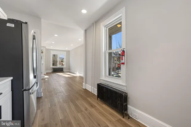 a view of a hallway view with wooden floor and staircase