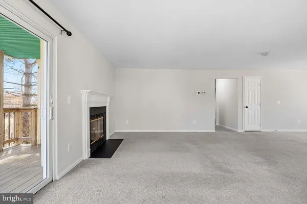 a view of empty room with furniture and fireplace
