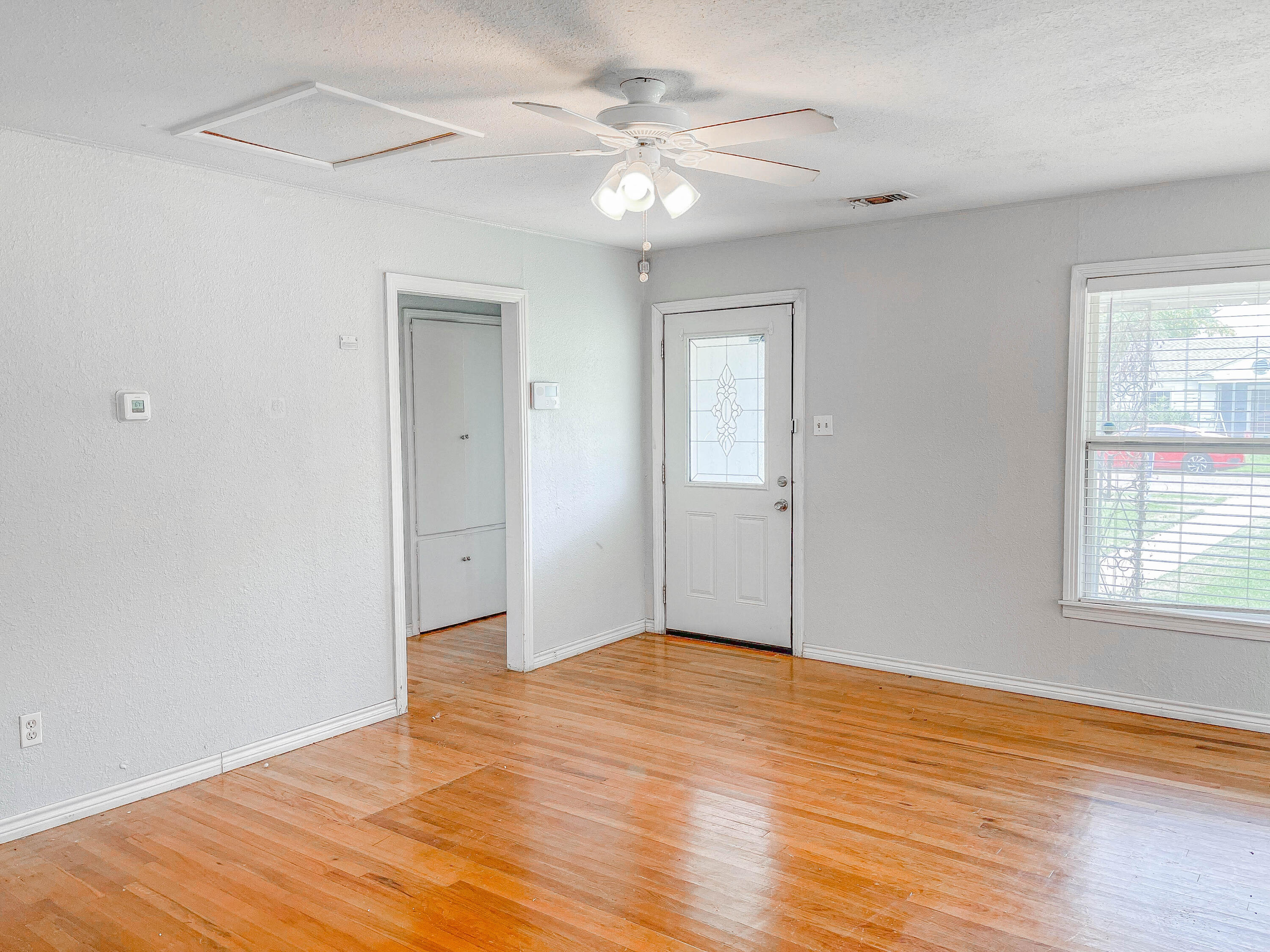 3418 26th Street Lubbock, TX 79410 - Photo 12 of 16 wooden floor in an empty room with a window