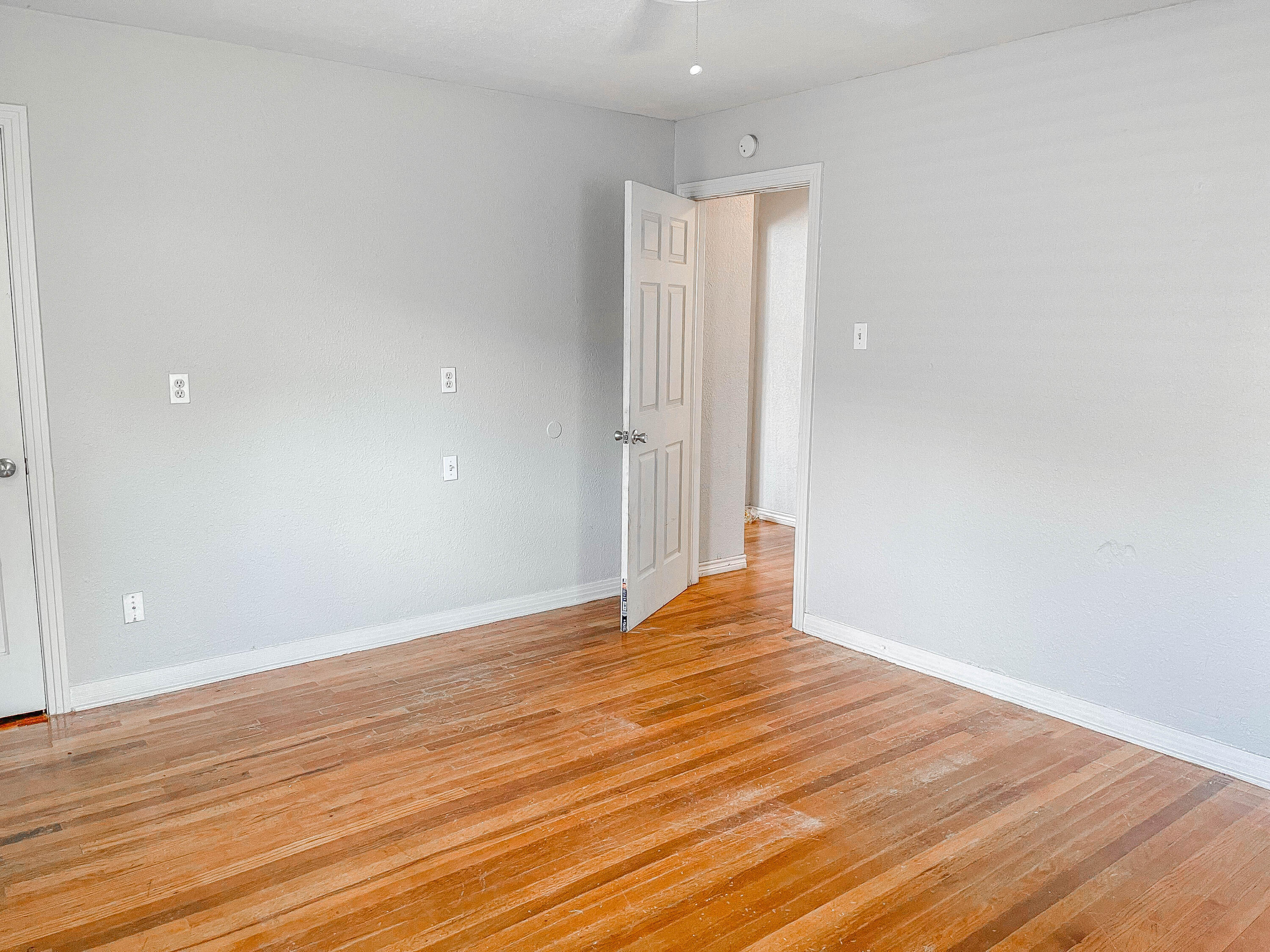 3418 26th Street Lubbock, TX 79410 - Photo 2 of 16 a view of an empty room with wooden floor