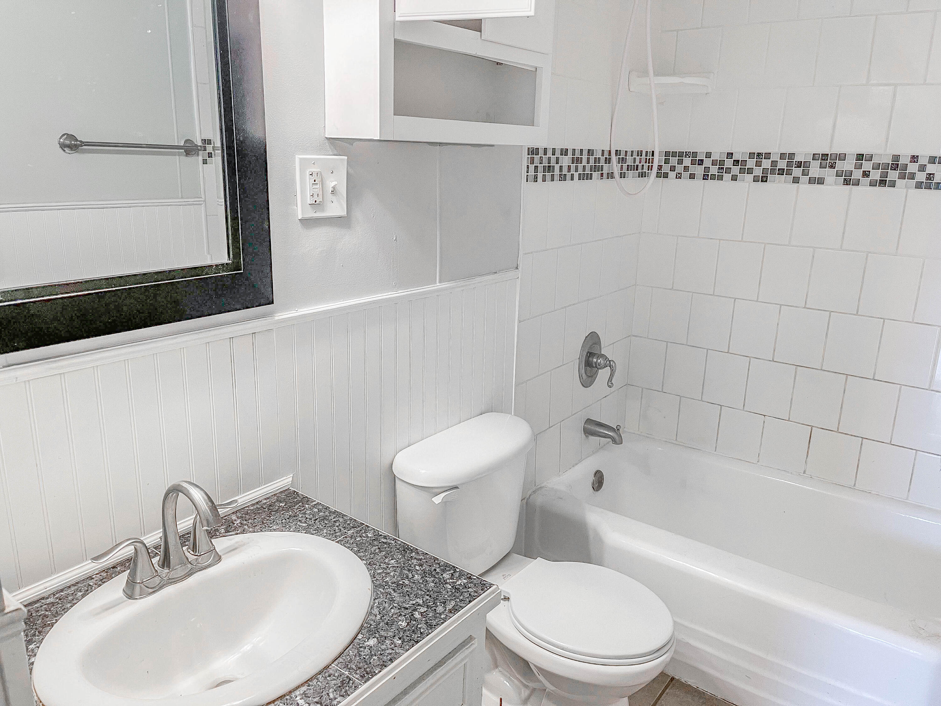 3418 26th Street Lubbock, TX 79410 - Photo 4 of 16 a white toilet sitting next to a bathroom sink