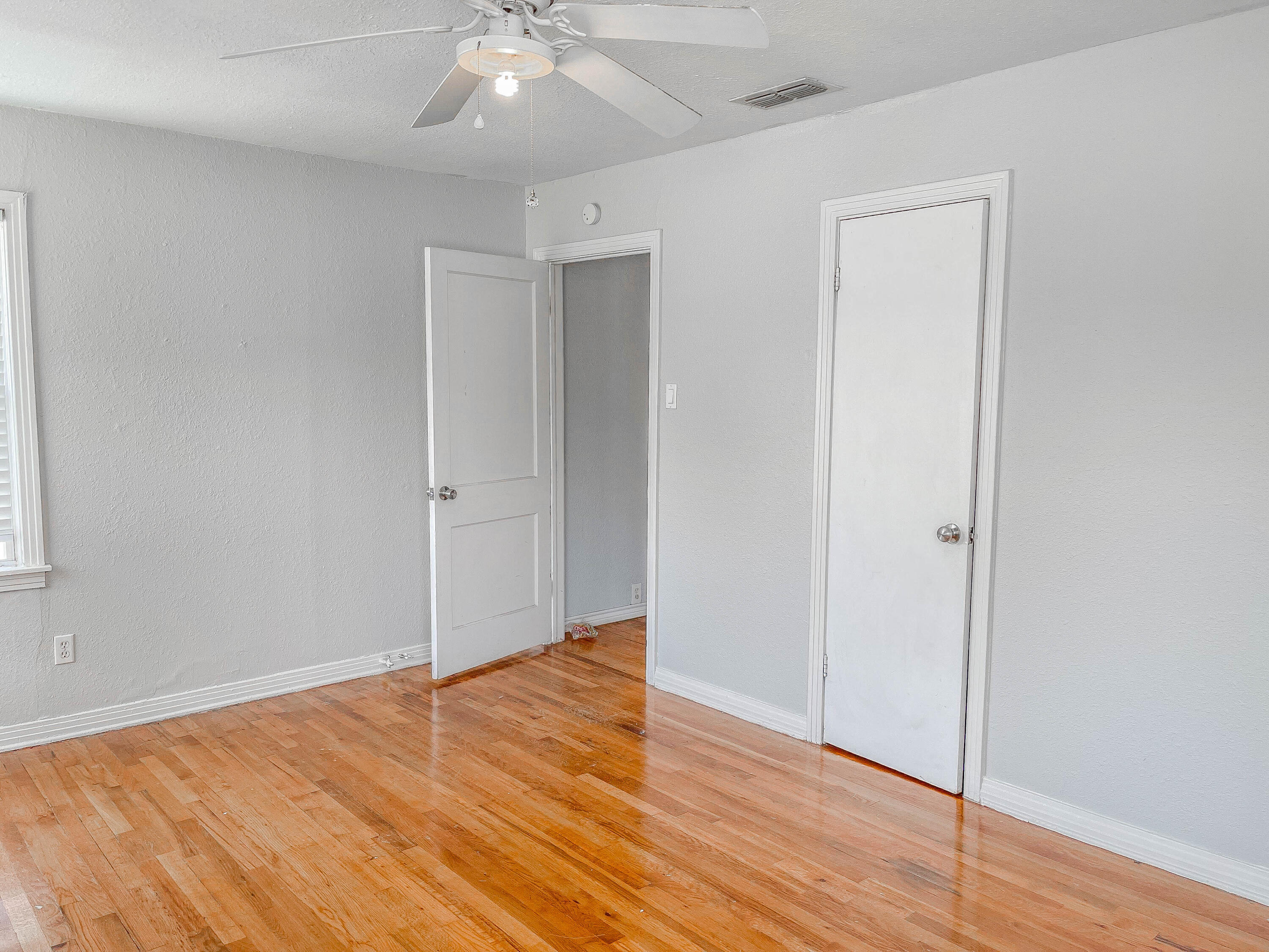 3418 26th Street Lubbock, TX 79410 - Photo 5 of 16 a view of an empty room with wooden floor