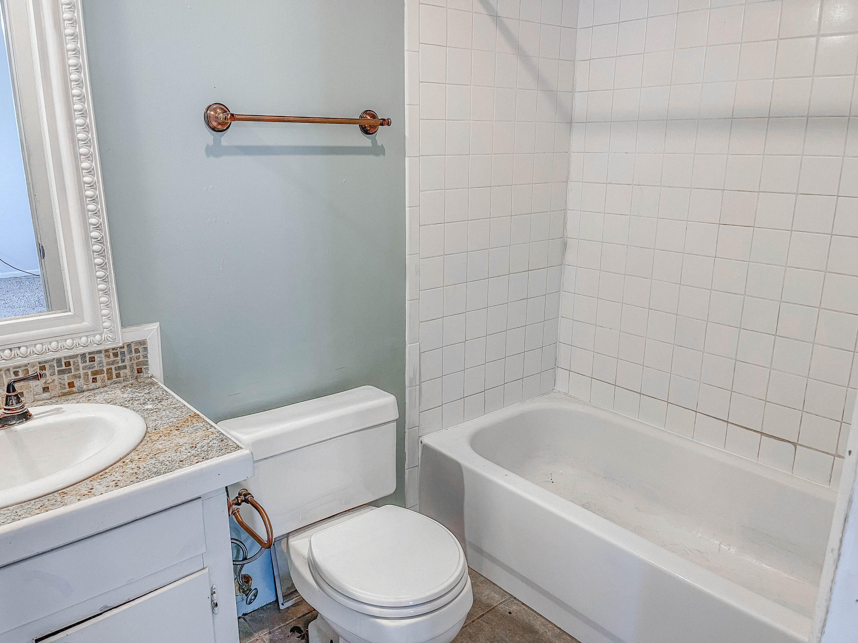 3418 26th Street Lubbock, TX 79410 - Photo 7 of 16 a white toilet sitting next to a bath tub