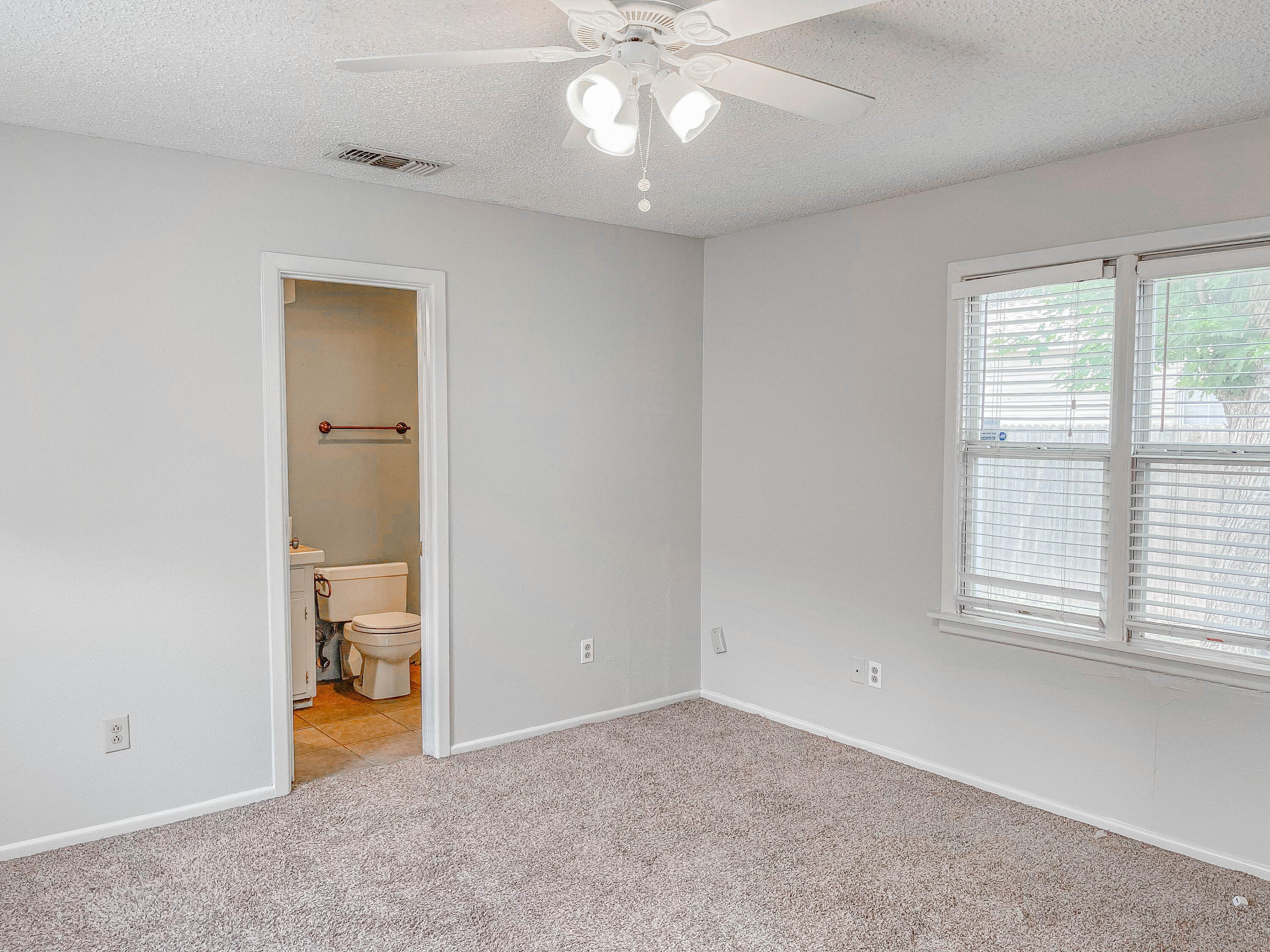 3418 26th Street Lubbock, TX 79410 - Photo 9 of 16 a view of an empty room with a window