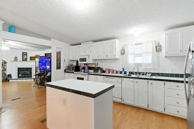 a white bath tub sitting next to a bathroom sink