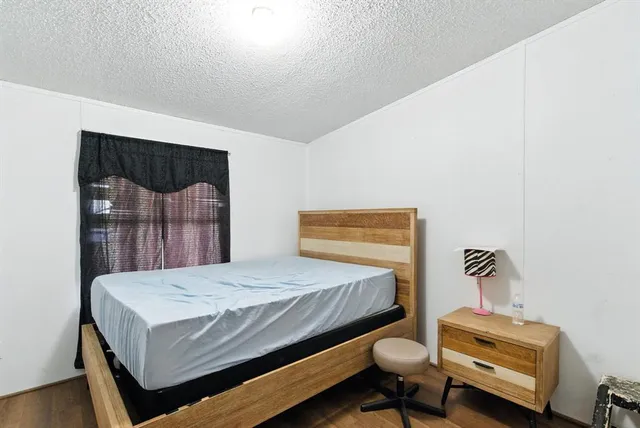 a bedroom with a bed and lamp