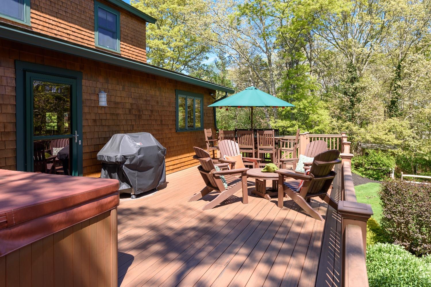 51 Sequattom Road Harwich, MA 02645 - Photo 23 of 35 a view of a patio with table and chairs under an umbrella