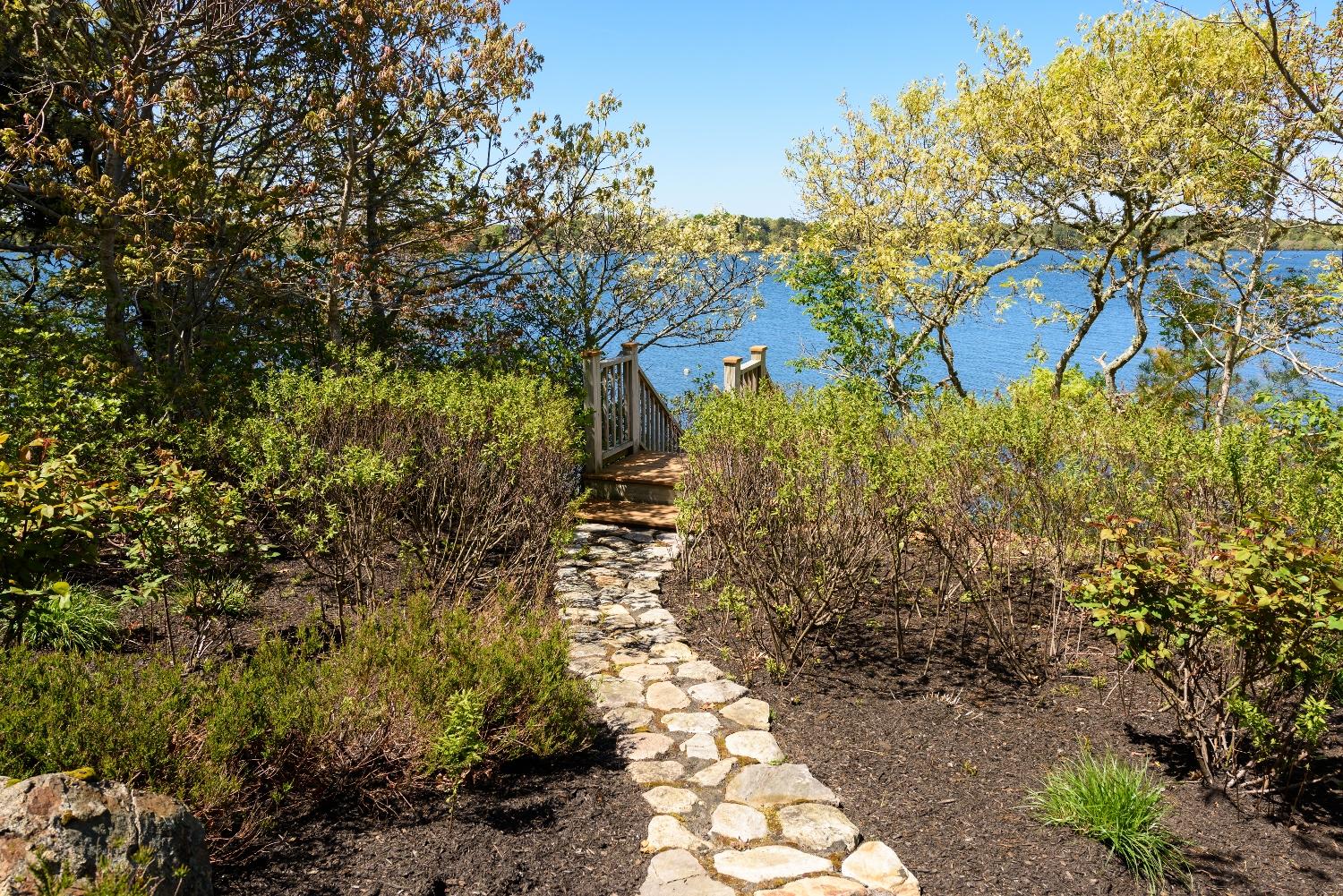 51 Sequattom Road Harwich, MA 02645 - Photo 28 of 35 a view of a yard with plants and large trees