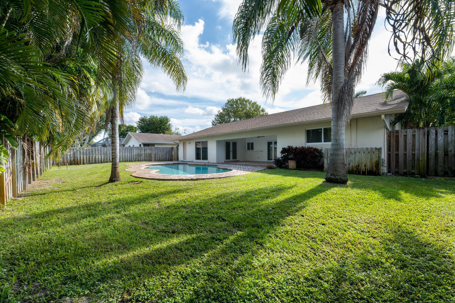 4695 Brandywine Drive Boca Raton, FL 33487 - Photo 2 of 28 a front view of house with yard and green space