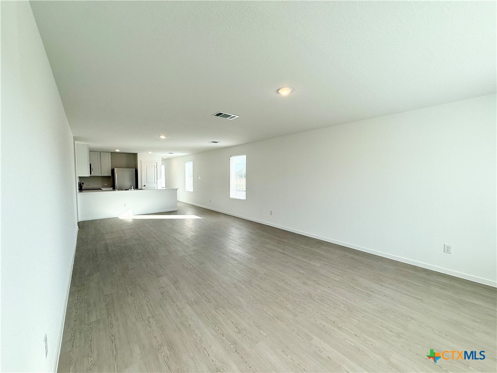 311 Moscato Road New Braunfels, TX 78130 - Photo 12 of 38 an empty room with a empty space and windows