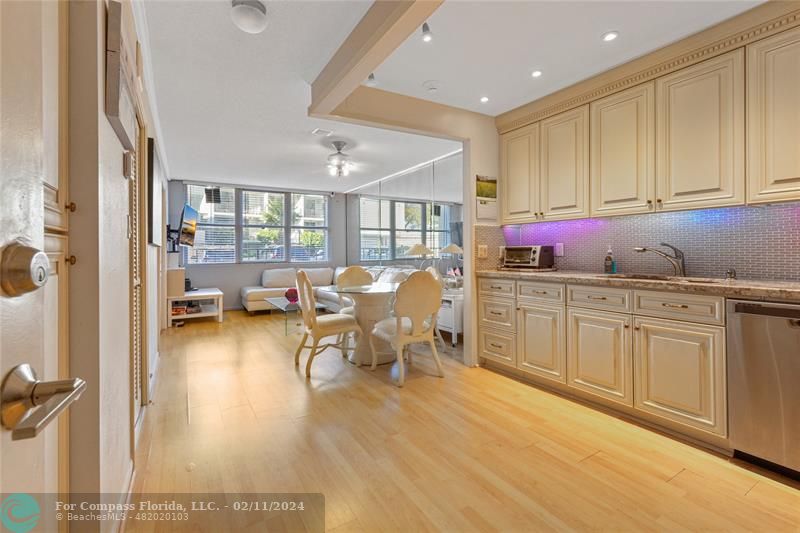 a kitchen with sink cabinets and dining table view