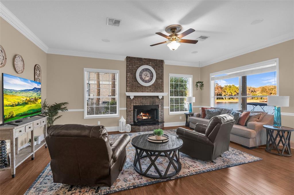 1425 Riviera Drive Kissimmee, FL 34744 - Photo 10 of 82 a living room with furniture a fireplace and a flat screen tv