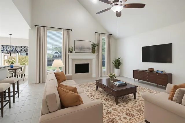 a living room with furniture a fireplace and a flat screen tv