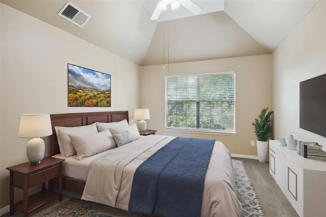 a bedroom with bed and a flat screen tv