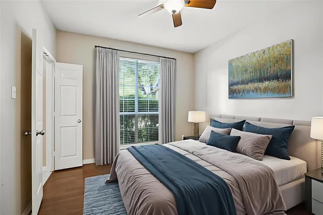 a bedroom with a bed and a painting on the wall