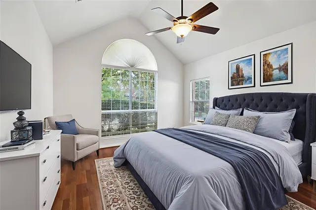 a spacious bedroom with a bed a couch and a window