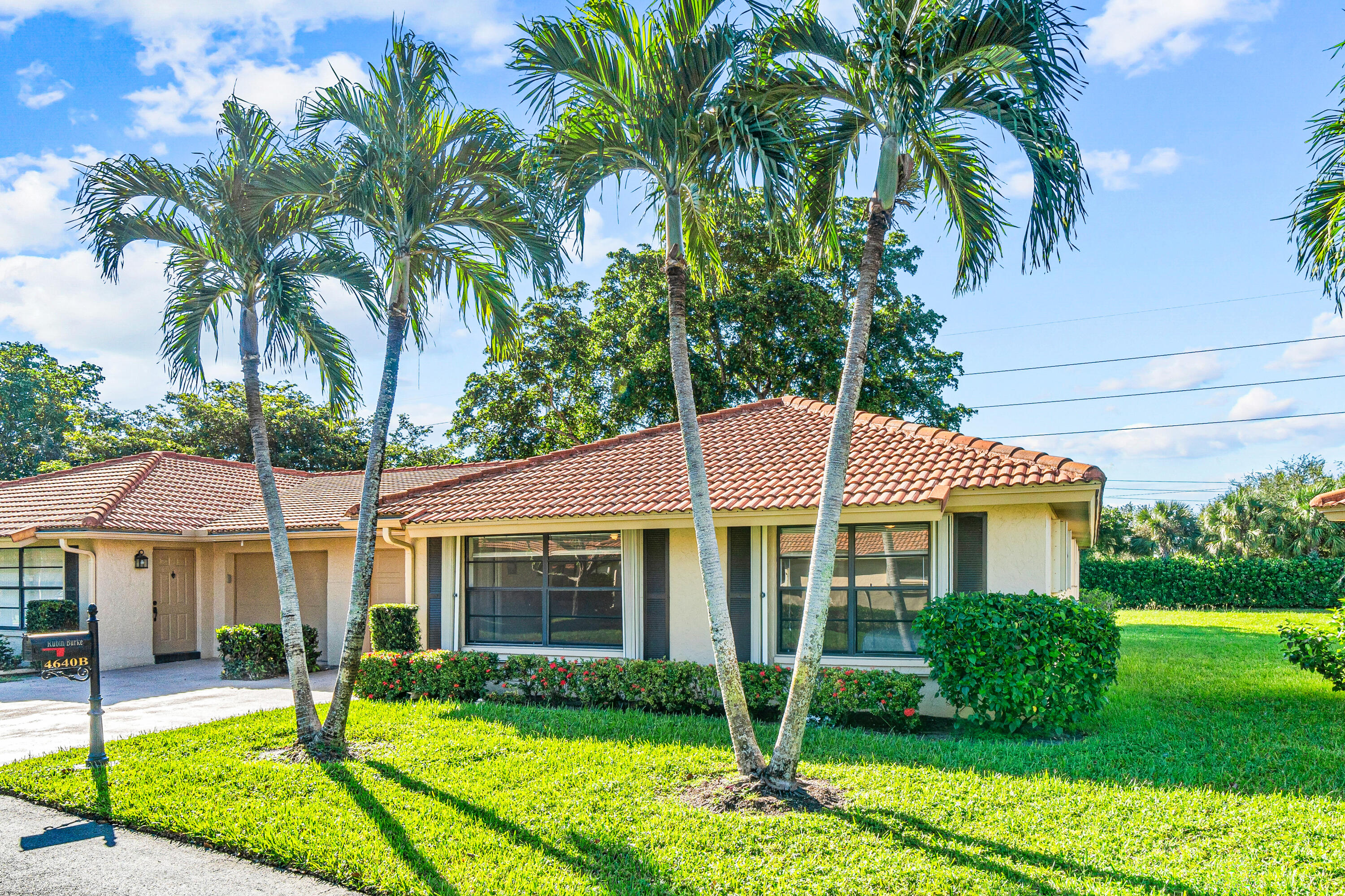 4640 Rosewood Tree Court, Unit B Boynton Beach, FL 33436 - Photo 1 of 27 a view of a house with a yard and potted plants