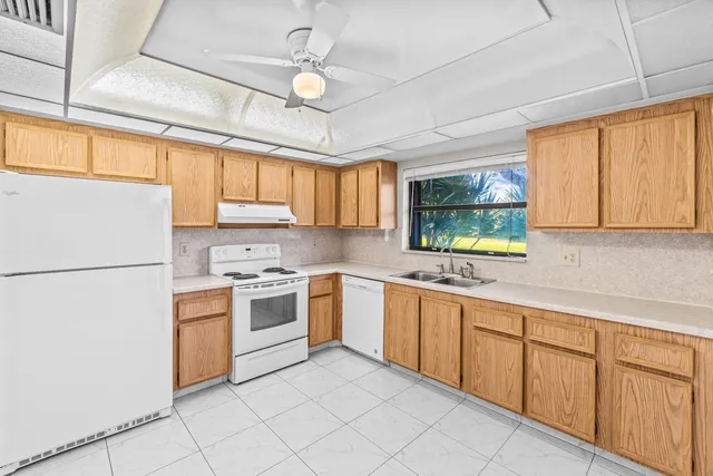 a kitchen with a stove top oven sink and window