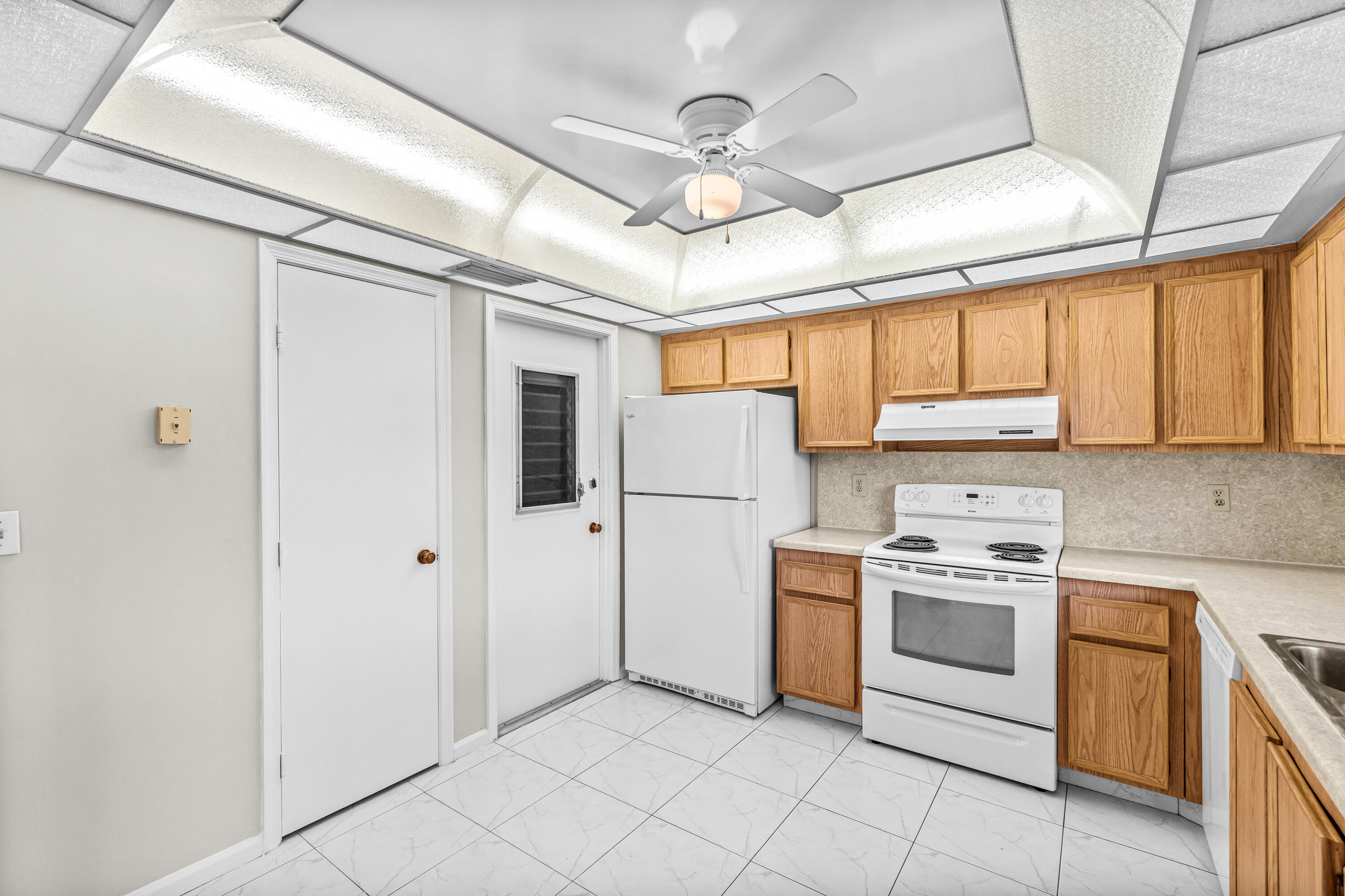 4640 Rosewood Tree Court, Unit B Boynton Beach, FL 33436 - Photo 14 of 27 a kitchen with a stove top oven sink and window