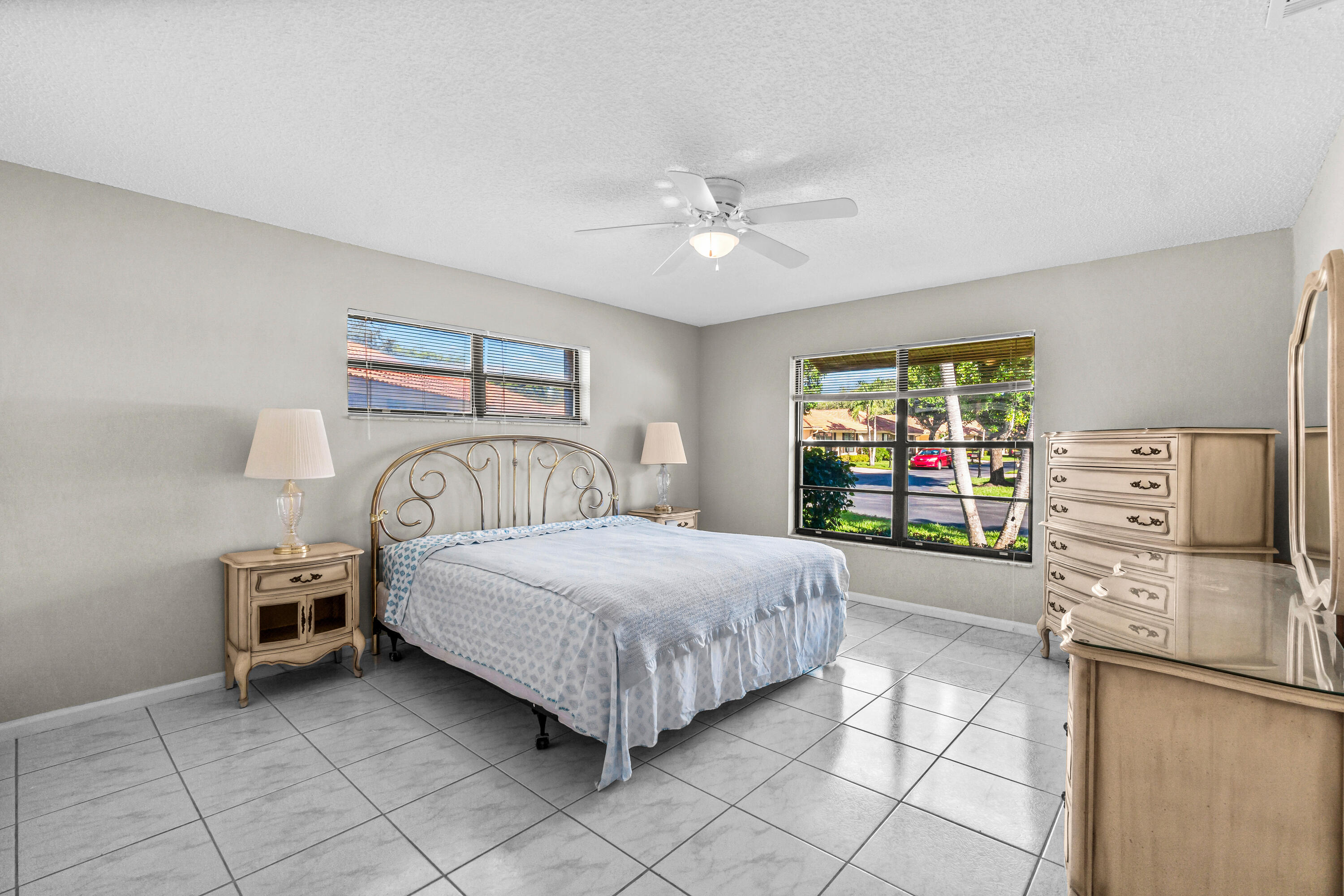 4640 Rosewood Tree Court, Unit B Boynton Beach, FL 33436 - Photo 16 of 27 a bedroom with a bed and a television