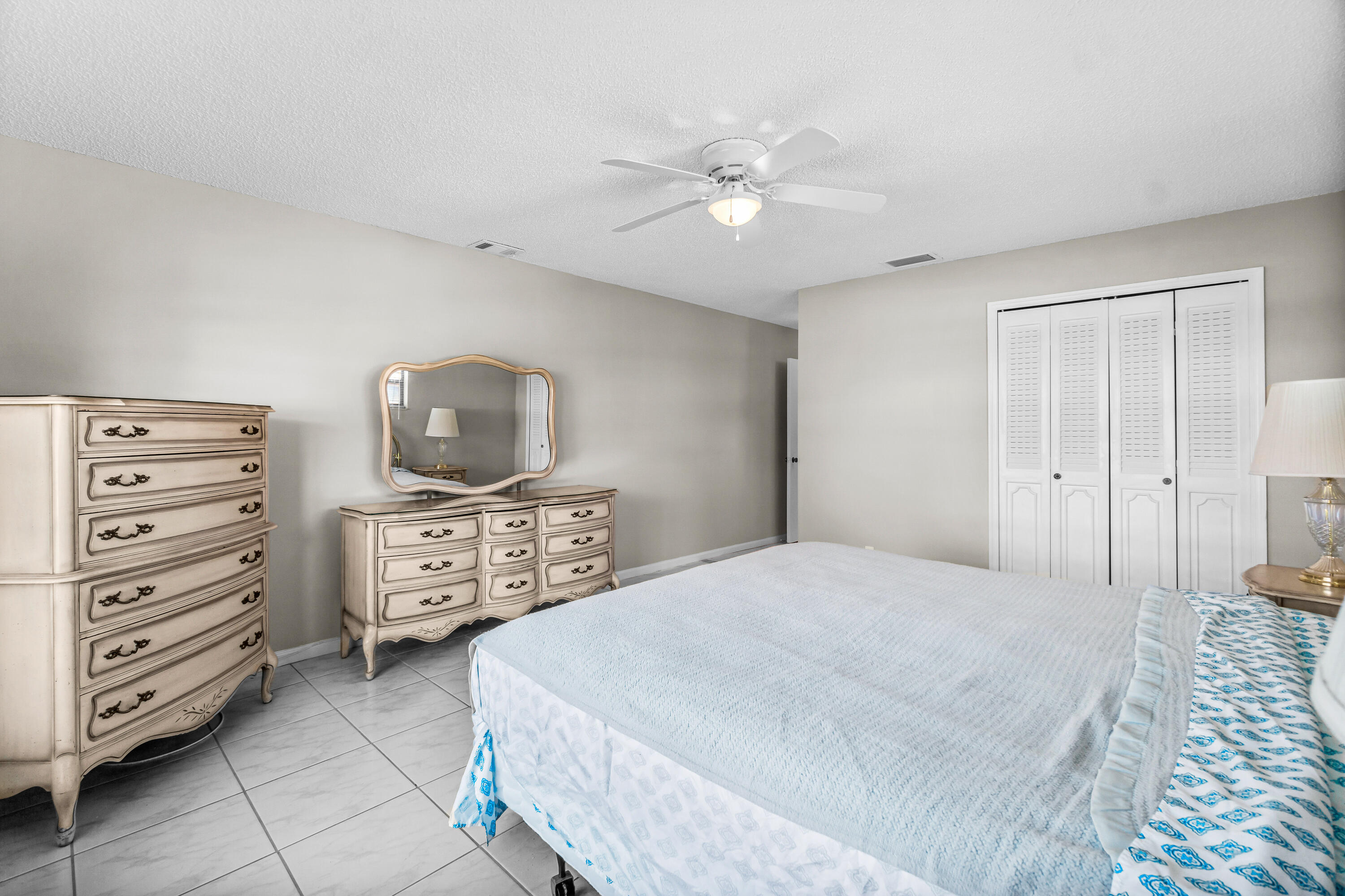 4640 Rosewood Tree Court, Unit B Boynton Beach, FL 33436 - Photo 17 of 27 a bedroom with a bed and a tv