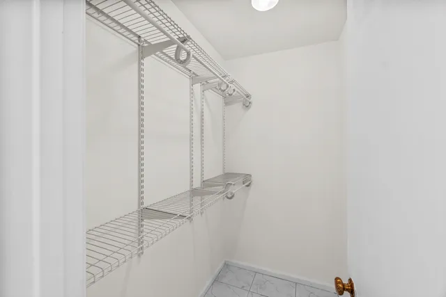 a bathroom with a granite countertop sink a toilet a mirror a vanity a bathtub and shower