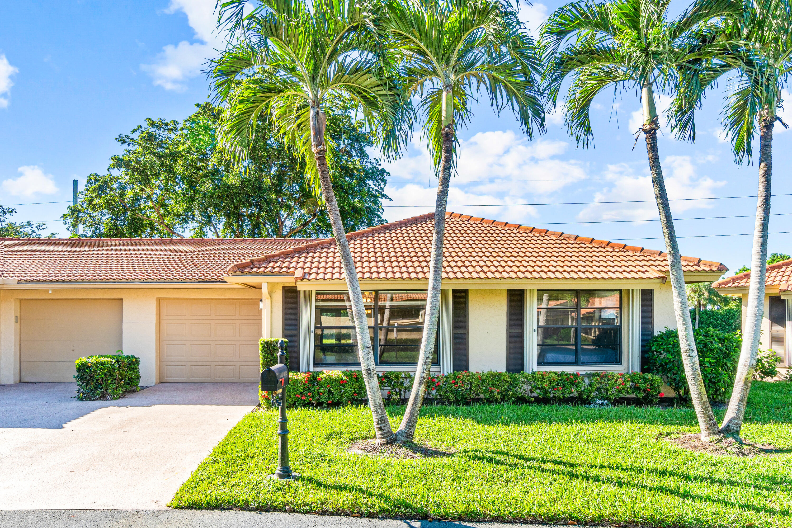 4640 Rosewood Tree Court, Unit B Boynton Beach, FL 33436 - Photo 2 of 27 a view of a house with a yard and plants