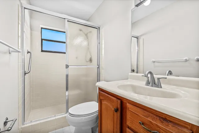 a bathroom with a sink a toilet and mirror