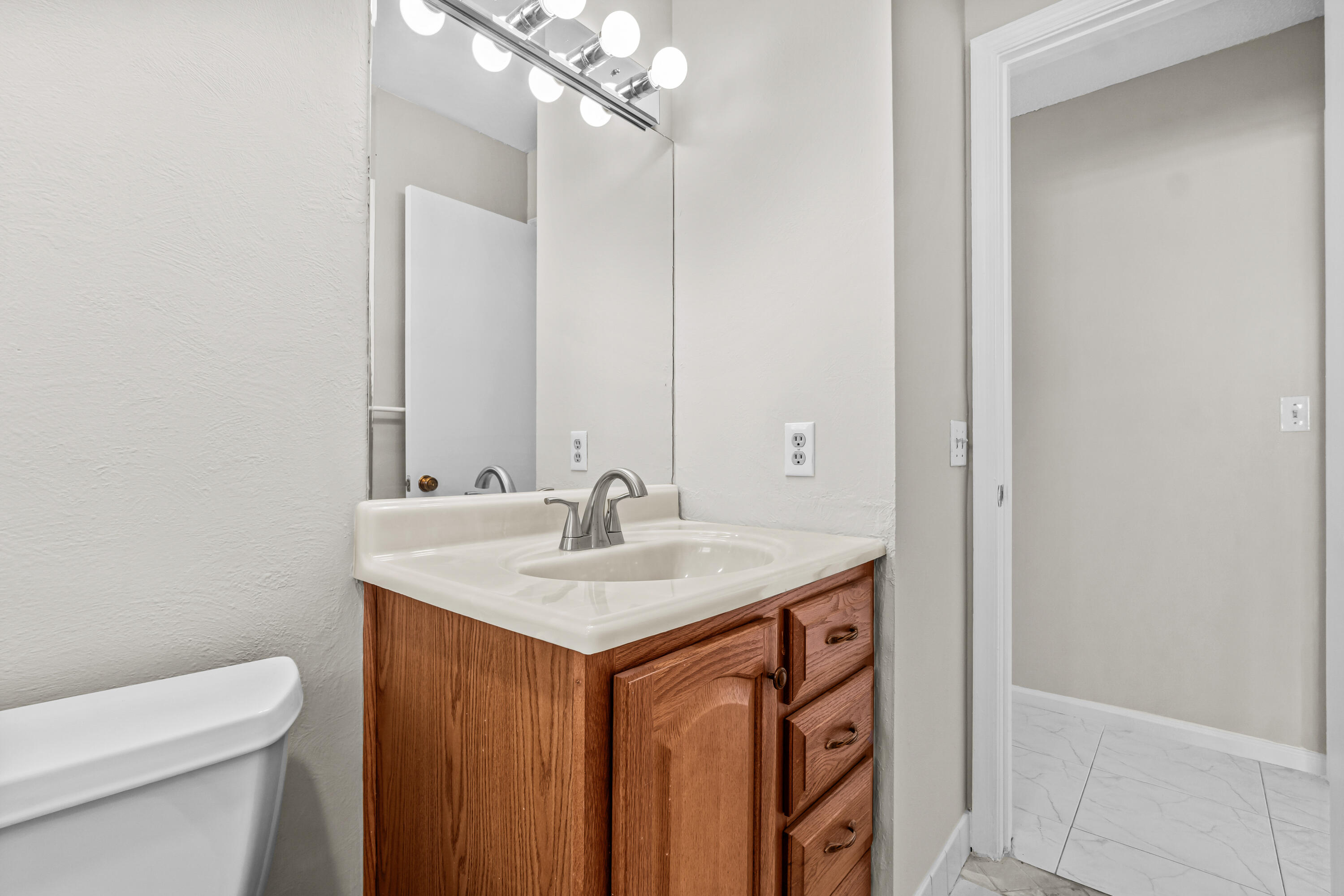4640 Rosewood Tree Court, Unit B Boynton Beach, FL 33436 - Photo 24 of 27 a bathroom with a sink a toilet and mirror