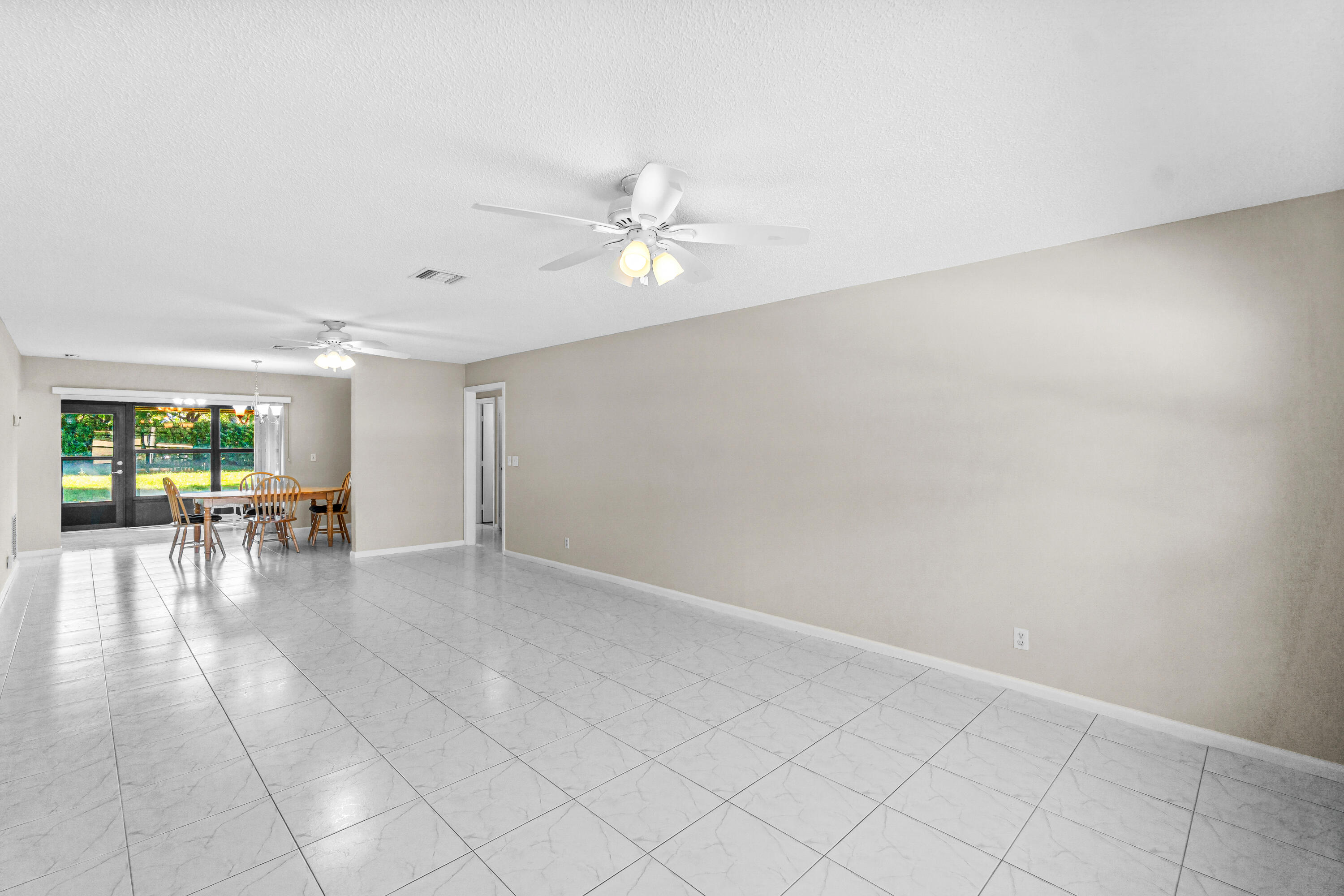 4640 Rosewood Tree Court, Unit B Boynton Beach, FL 33436 - Photo 3 of 27 wooden floor in an empty room with a window