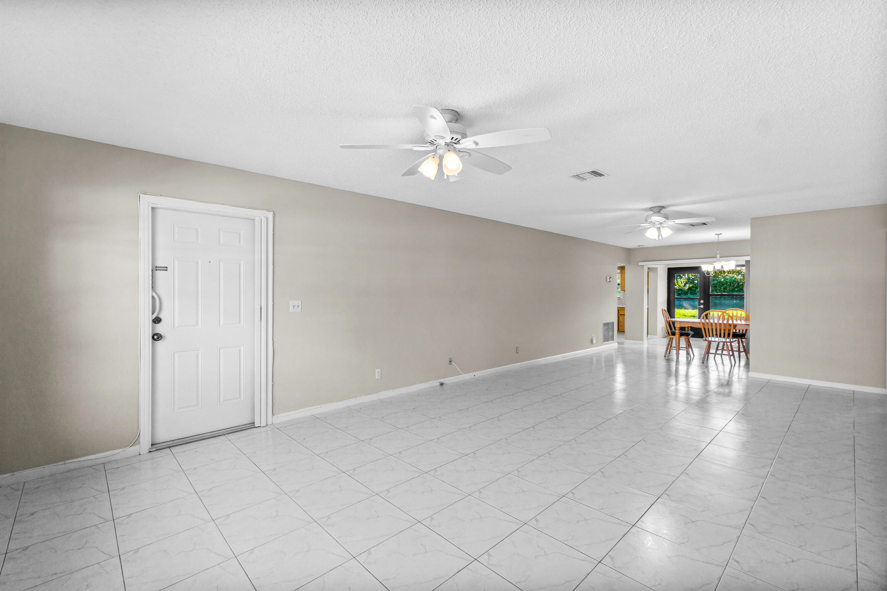 4640 Rosewood Tree Court, Unit B Boynton Beach, FL 33436 - Photo 4 of 27 wooden floor in an empty room with a window