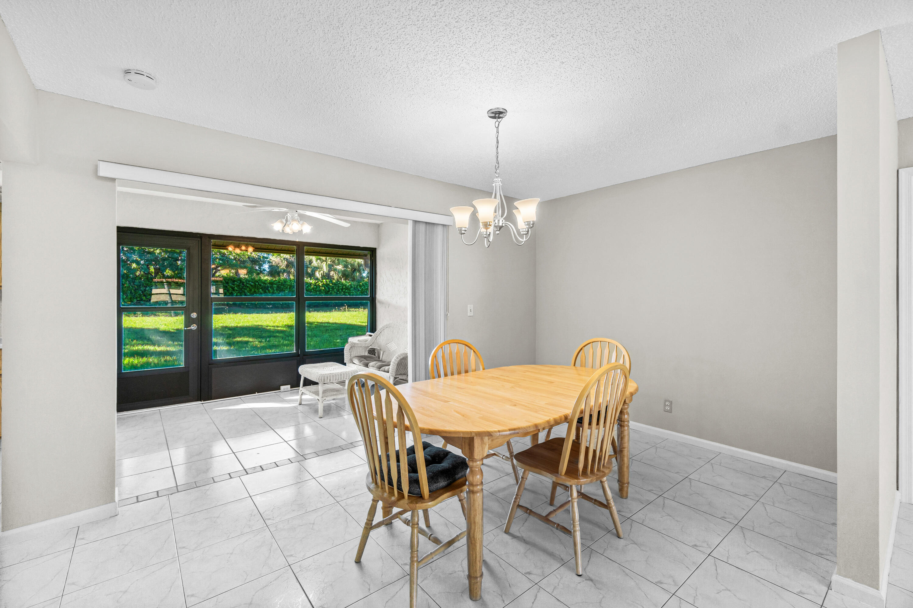 4640 Rosewood Tree Court, Unit B Boynton Beach, FL 33436 - Photo 7 of 27 a view of a dining room with furniture window and outside view
