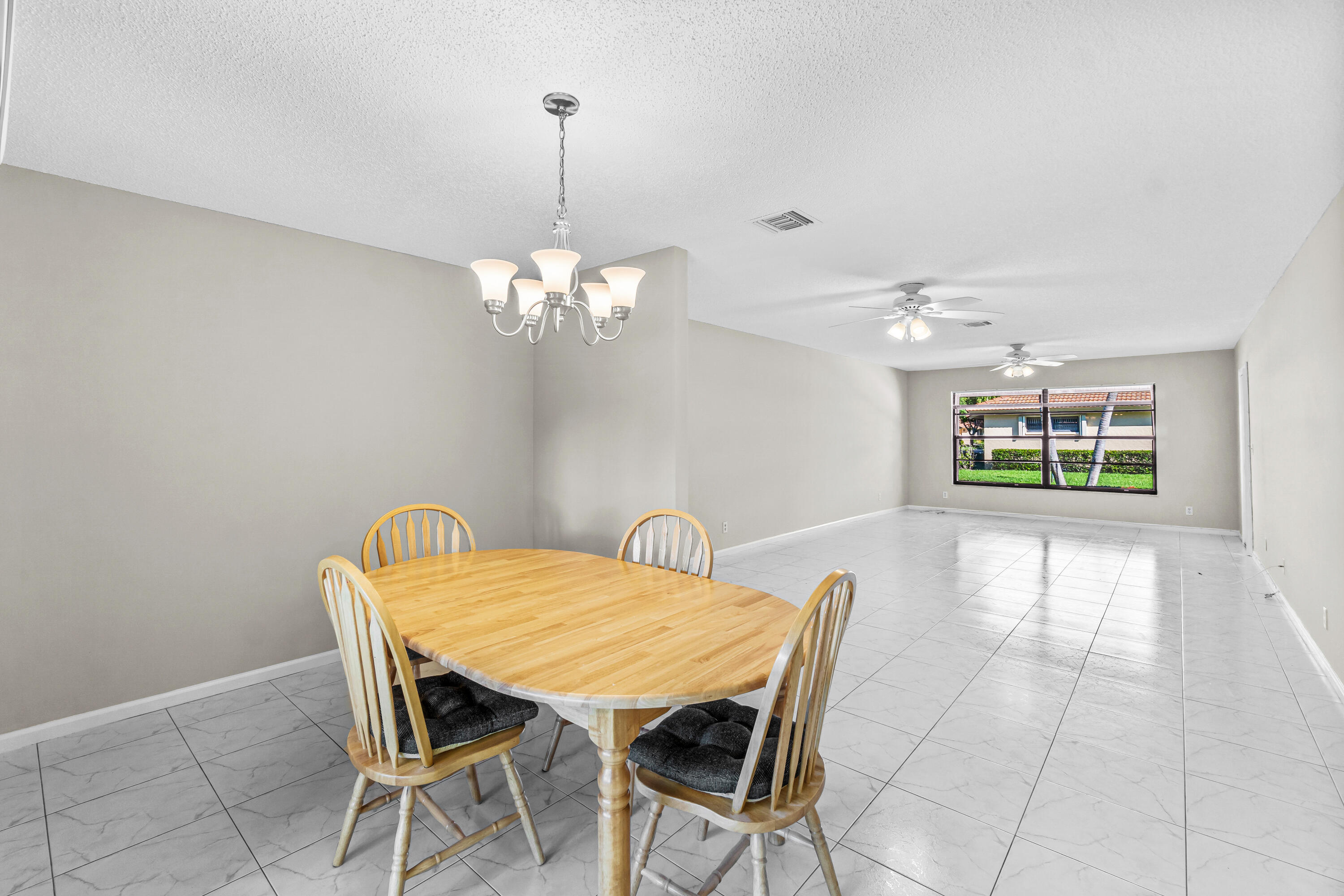 4640 Rosewood Tree Court, Unit B Boynton Beach, FL 33436 - Photo 8 of 27 a view of a dining room with furniture and chandelier