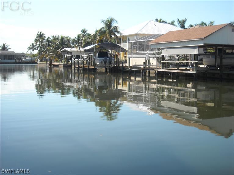 3351 Stringfellow Road St. James City, FL 33956 - Photo 2 of 2 a view of a house next to a lake with houses