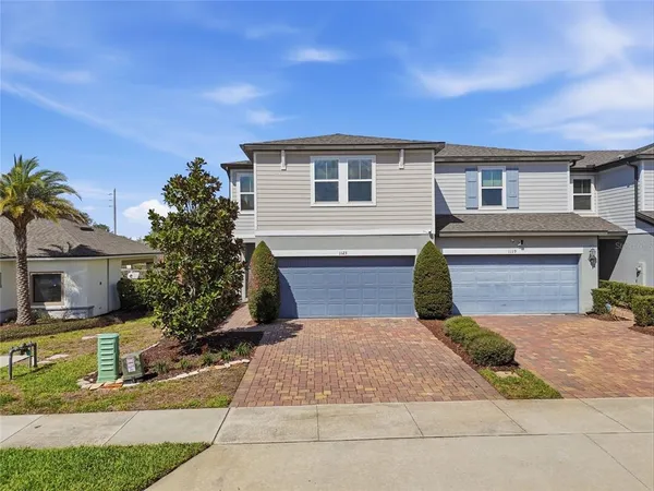 a front view of a house with a yard and garage