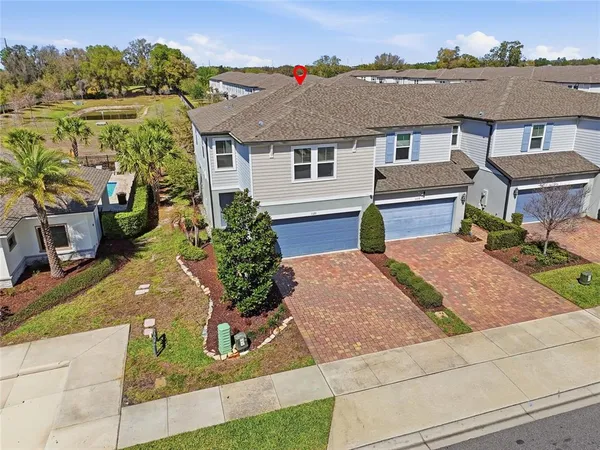 an aerial view of a house with yard