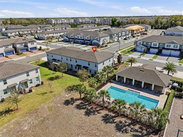 an aerial view of residential houses with outdoor space