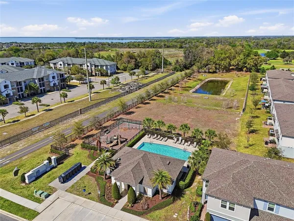 an aerial view of a house with swimming pool and lawn chairs