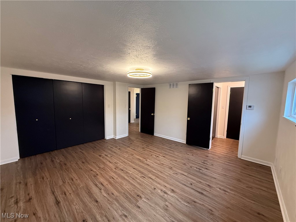522 North 3rd Street Toronto, OH 43964 - Photo 22 of 47 Unfurnished bedroom featuring a textured ceiling, wood finished floors, and a closet