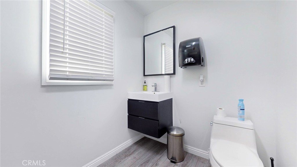 6851 Foothill Boulevard Tujunga, CA 91042 - Photo 26 of 50 a bathroom with a toilet sink and mirror