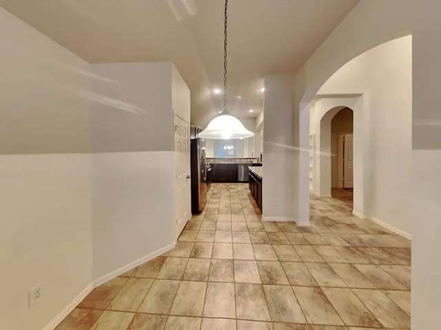 a kitchen with granite countertop wooden cabinets and stainless steel appliances