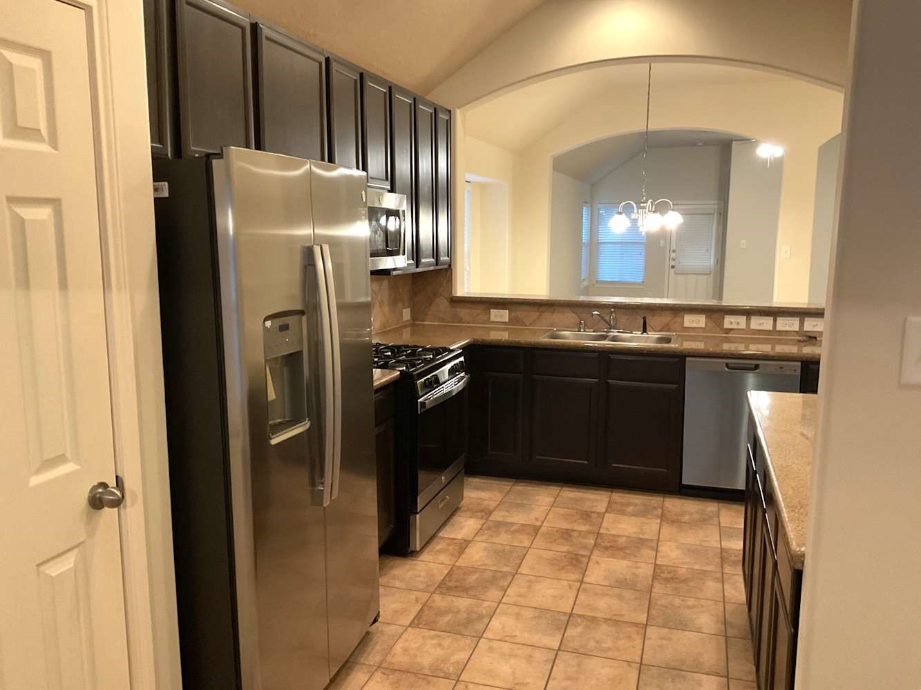 30619 Ginger Trace Drive Spring, TX 77386 - Photo 8 of 16 a kitchen with stainless steel appliances granite countertop a stove a refrigerator and a sink