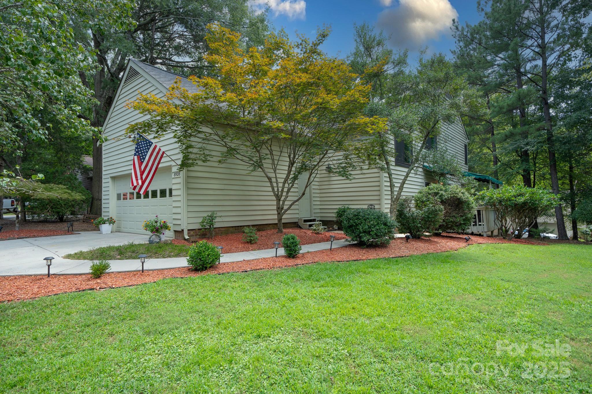 8928 St Croix Lane Charlotte, NC 28277 - Photo 1 of 37 a front view of a house with garden and sitting area