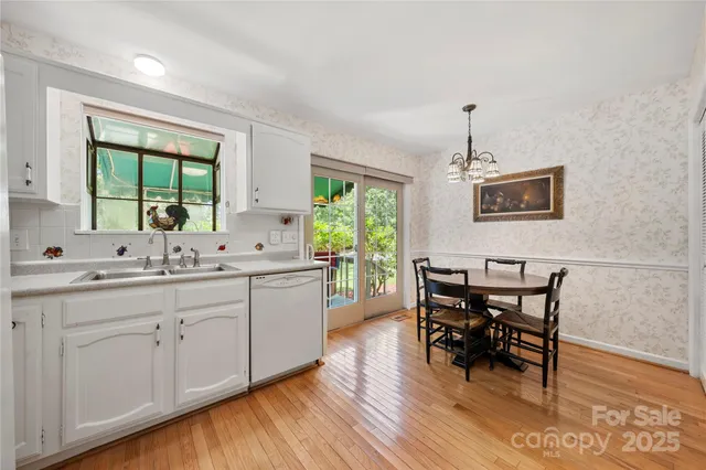 a kitchen with sink cabinets and wooden floor