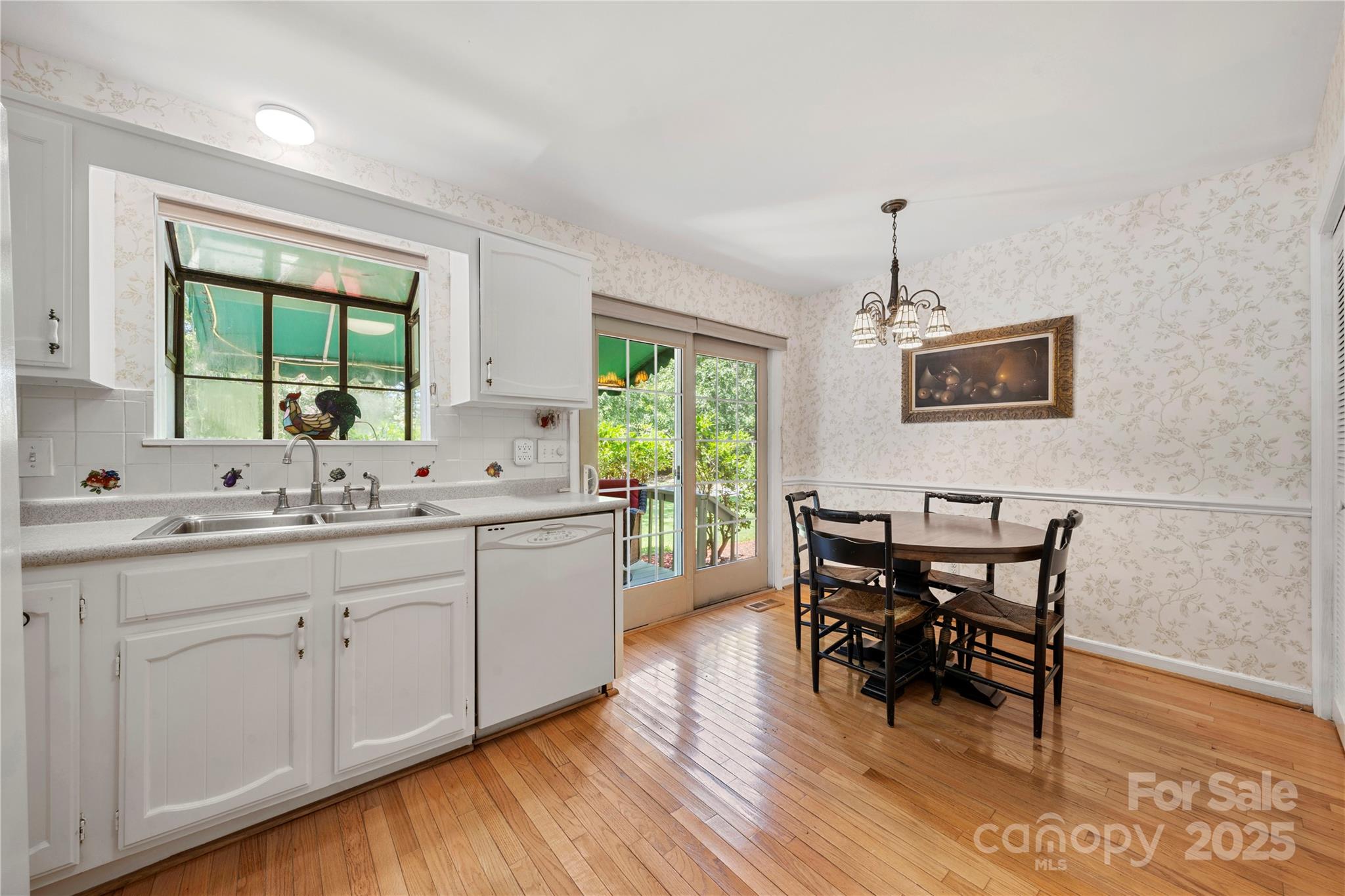 8928 St Croix Lane Charlotte, NC 28277 - Photo 13 of 37 a kitchen with sink cabinets and wooden floor
